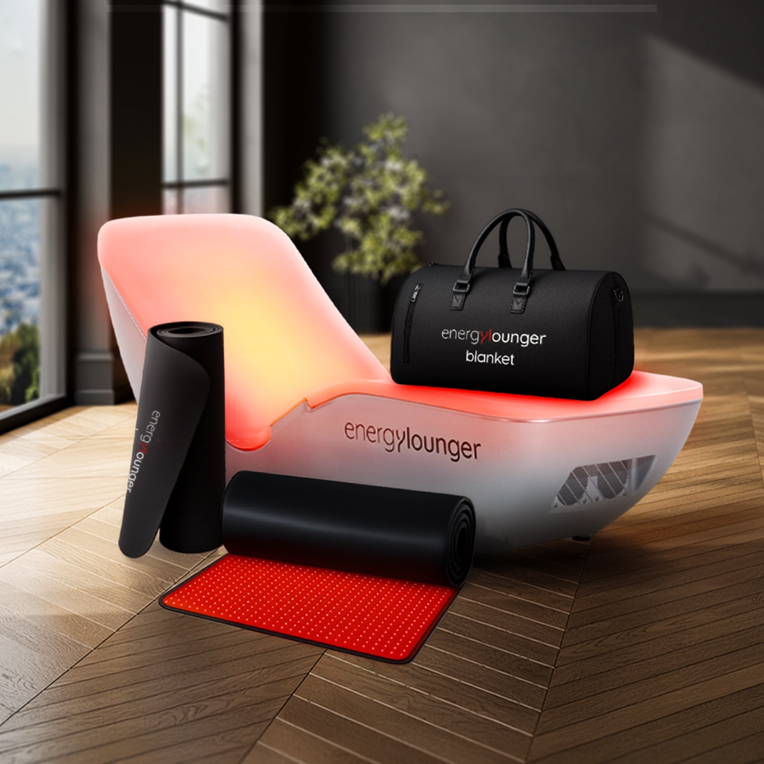 Energylounger product set including a chair, blanket, and accessories on a wooden floor.